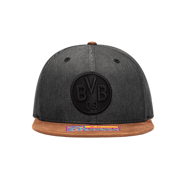 Front view of the Borussia Dortmund Orion Snapback with high structured crown, flat peak suede-like brim, and snapback closure, in Black/Brown.