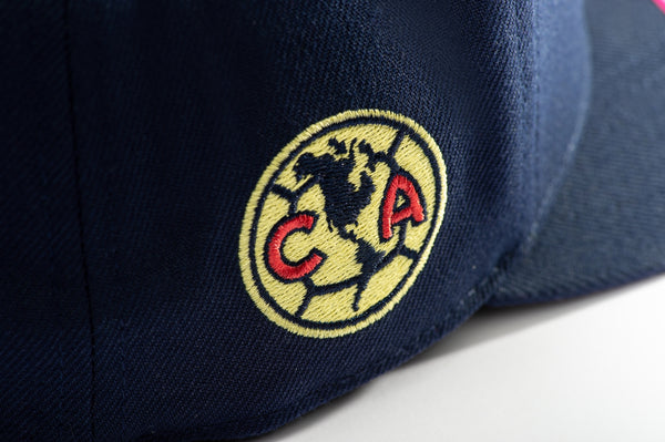 Club America Day of the Dead Snapback Hat with floral skull embroidered on the front, Club America embroidered on the side, "Dia de Muertos" embroidered on the back. The hat has a high crown, flat peak brim, and a snapback closure.