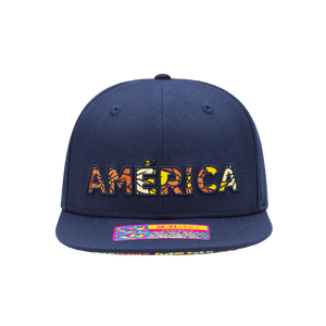 Club America Day of the Dead Snapback Hat with America script with marigold floral overlay embroidered on the front, Club America logo embroidered on the side, "Dia de Muertos" embroidered on the back, and marigold floral print on the under peak. The hat has a high crown, flat peak brim, and a snapback closure.